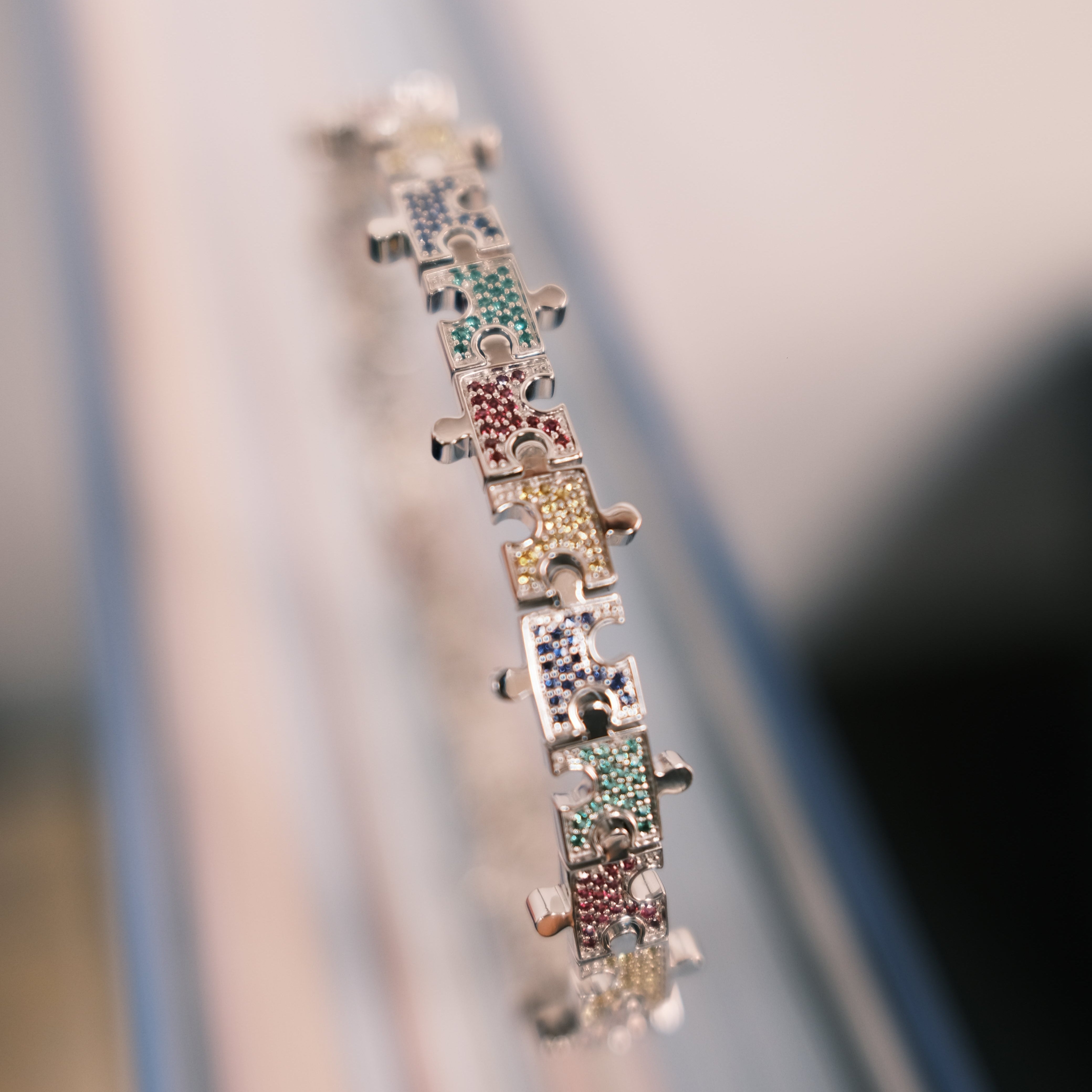JW Multicolored Puzzle bracelet on a book