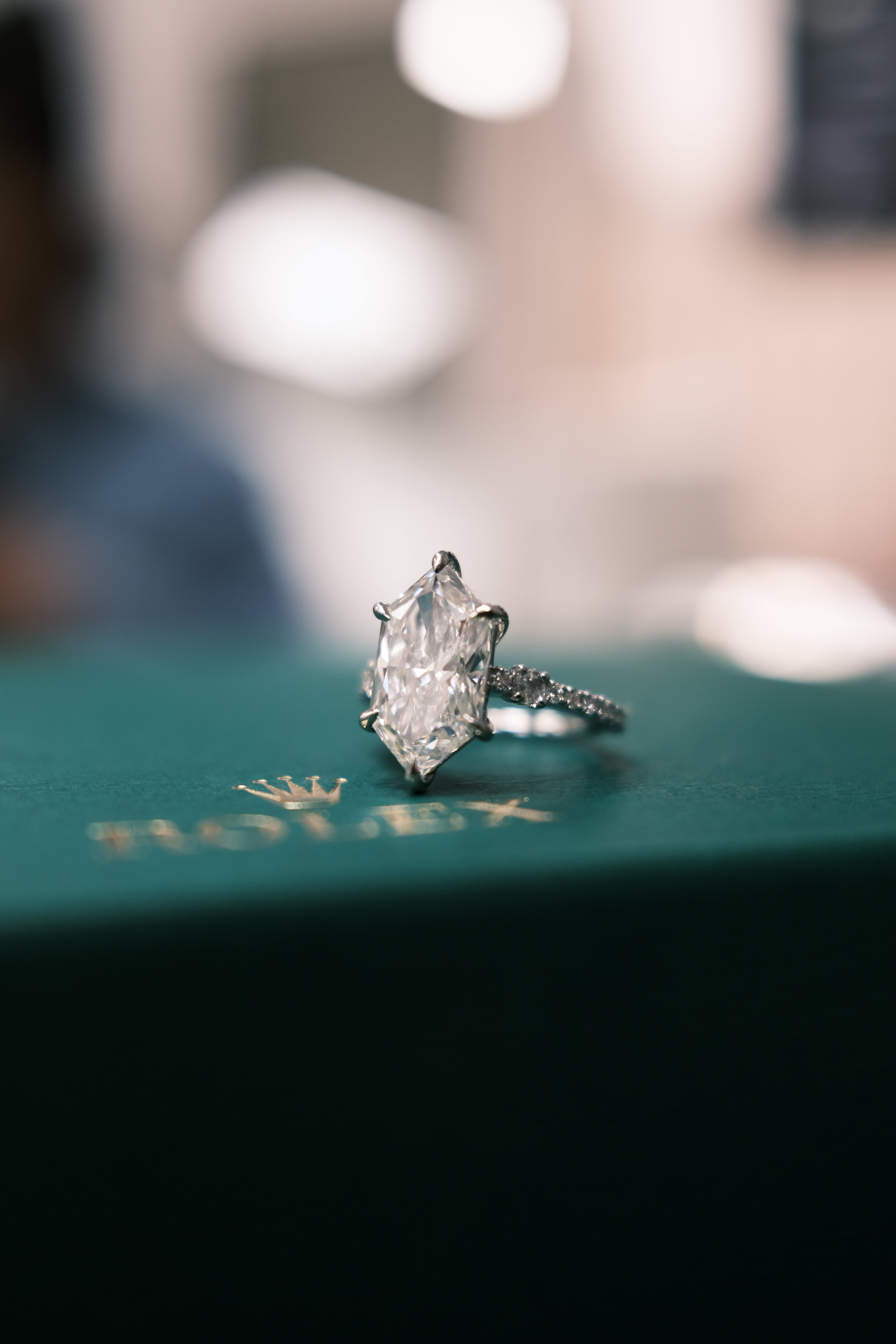 engagement ring on a Rolex box with blur background