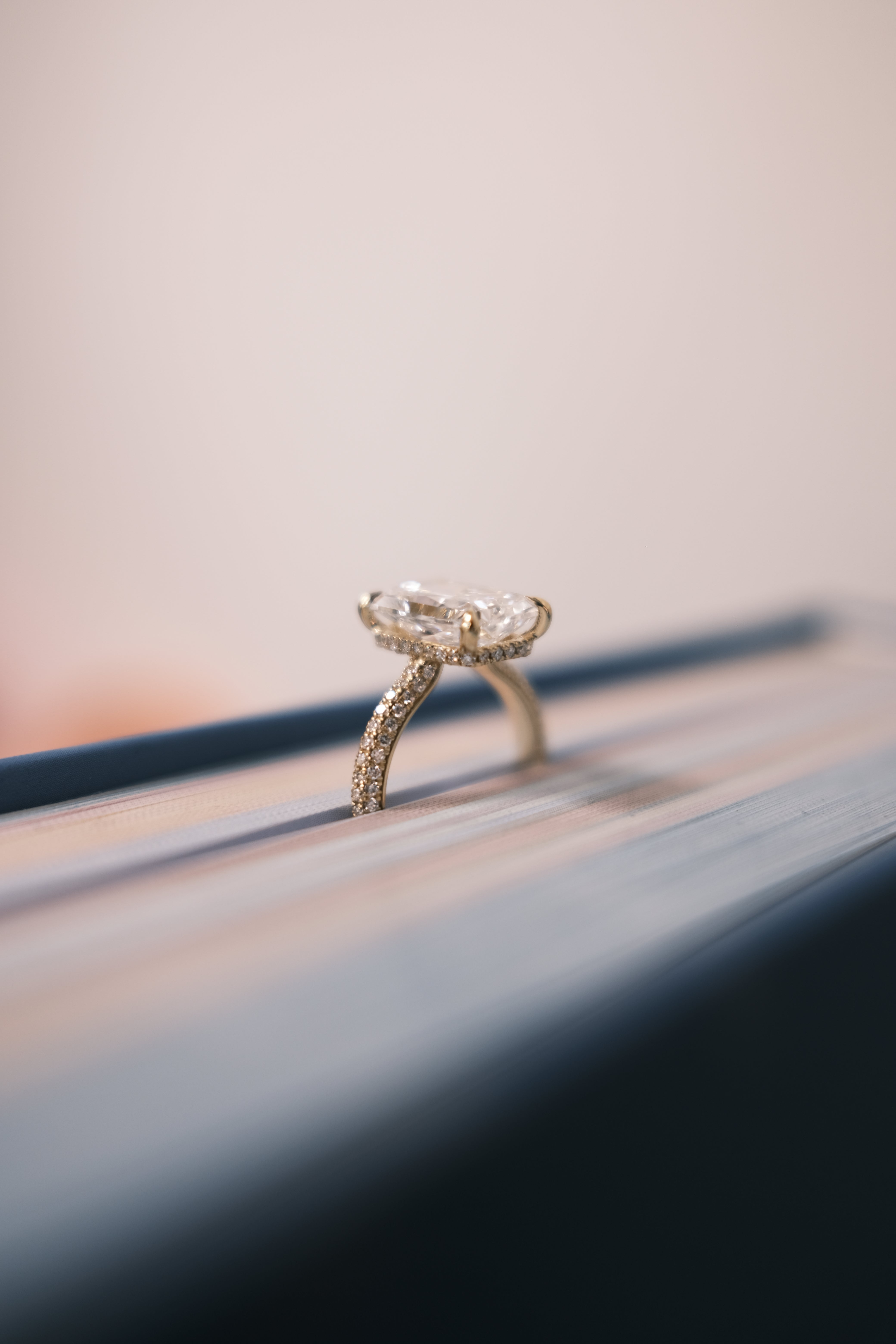 Diamond ring on a reflective surface with a blurred background